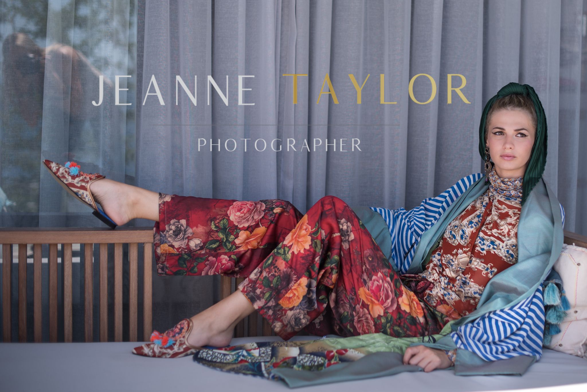 Model in colorful bohemian outfit with floral pants and striped sleeves