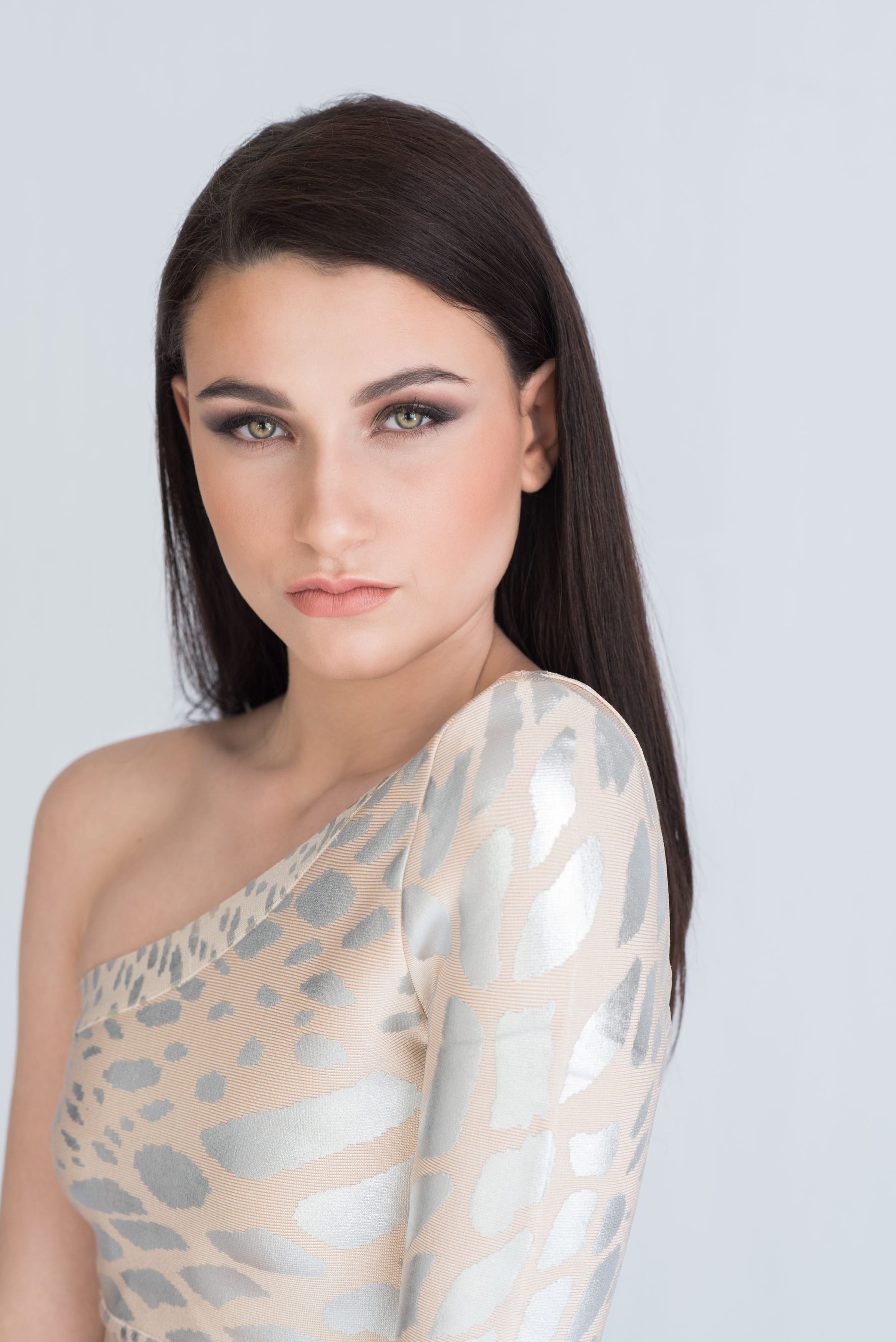 Woman in a one-shoulder metallic animal-print dress with dramatic makeup — portrait photography in Cape Town