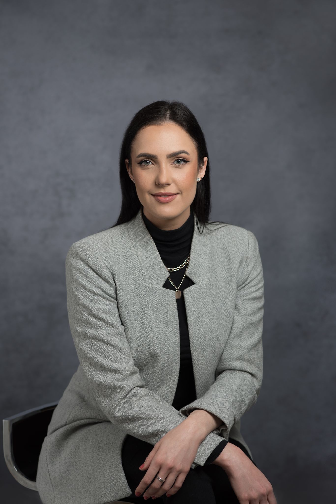 Professional woman in a gray herringbone blazer and black turtleneck — corporate portrait photography in Cape Town